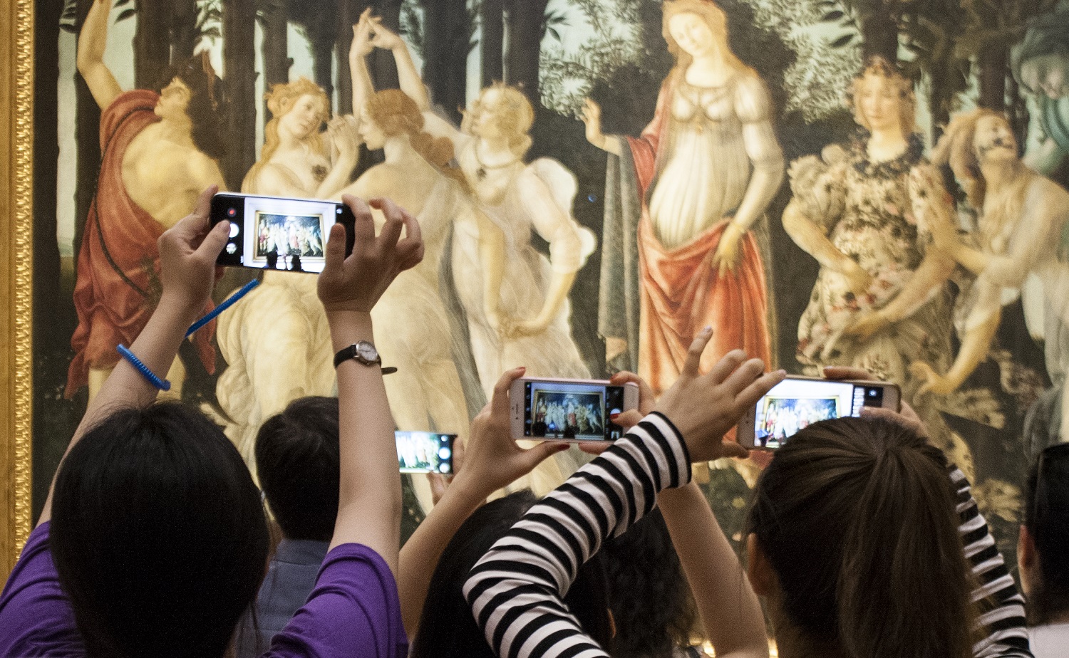 Visitors using digital technology and virtual reality at the modern Uffizi